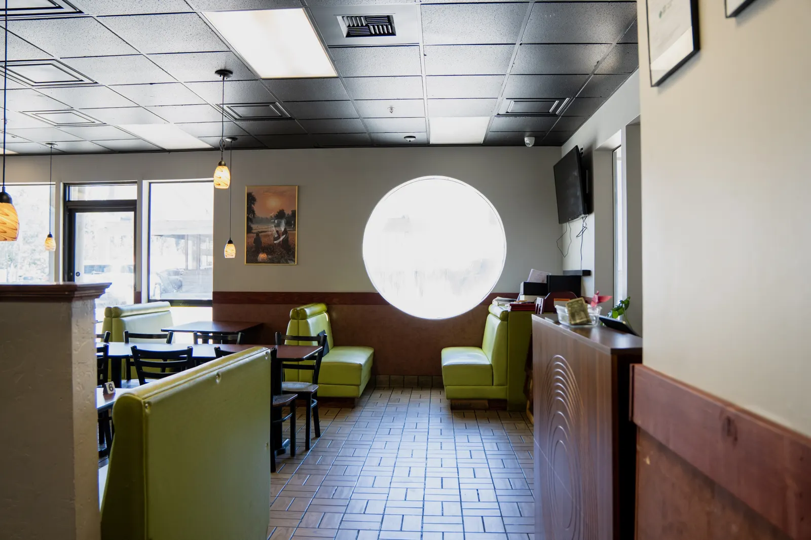Booths beside the round window in the Mehfil dining room